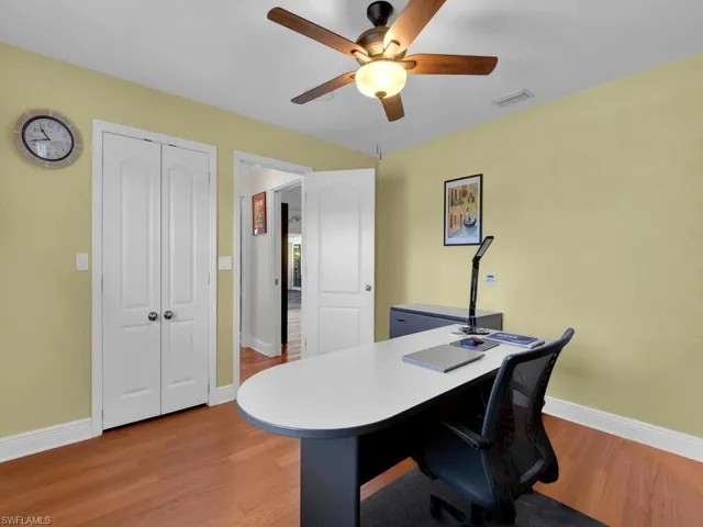 Office area with wood finished floors and ceiling fan