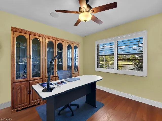 Home office featuring dark wood-style floors and a ceiling fan