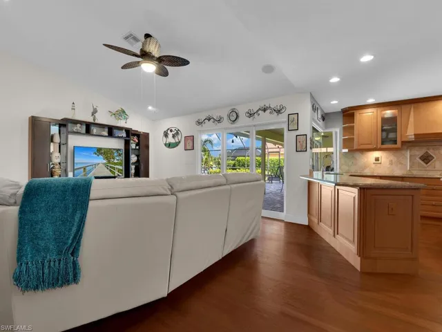 Living room featuring dark wood finished floors, recessed lighting, and ceiling fan