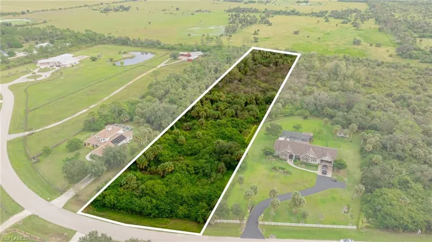 Overview of rural landscape featuring property boundaries highlighted and a large body of water