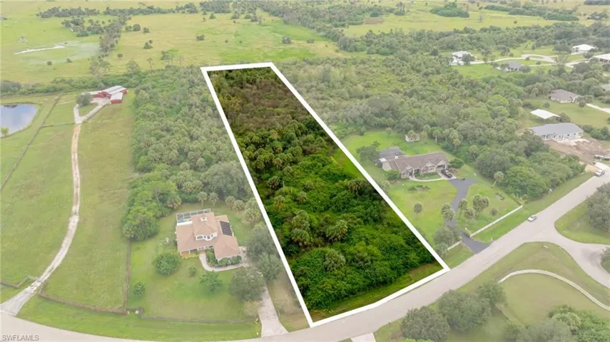 View of property location with a large body of water, rural landscape, and property parcel outlined