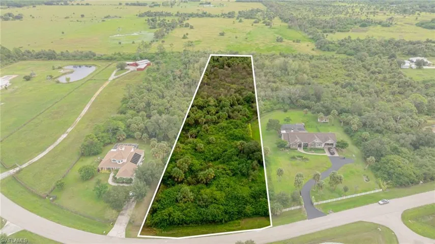 View of property location featuring rural landscape, a nearby body of water, and property parcel outlined