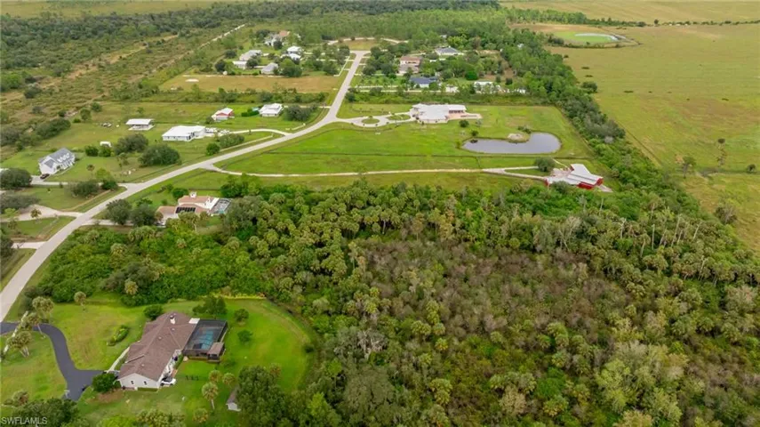 Aerial overview of property's location with rural landscape and a forest
