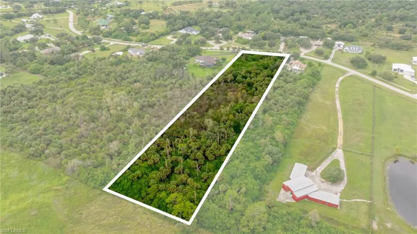 View of property location featuring property parcel outlined and a heavily wooded area