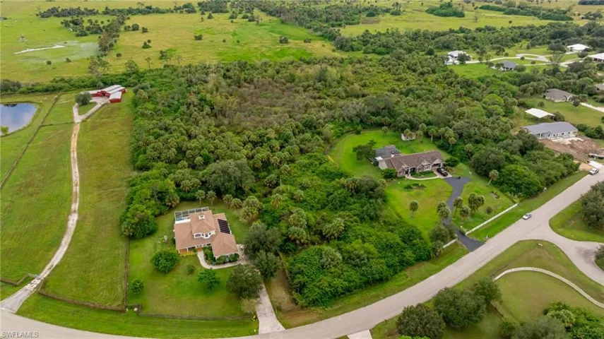 Aerial view of property and surrounding area with a nearby body of water and rural landscape
