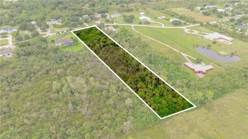Aerial overview of property's location featuring property parcel outlined and a large body of water