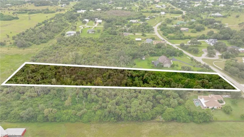 View of property location with a heavily wooded area and property parcel outlined