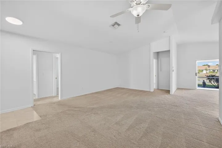Unfurnished room featuring light colored carpet and ceiling fan