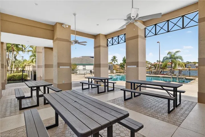 View of patio featuring ceiling fan and a community pool