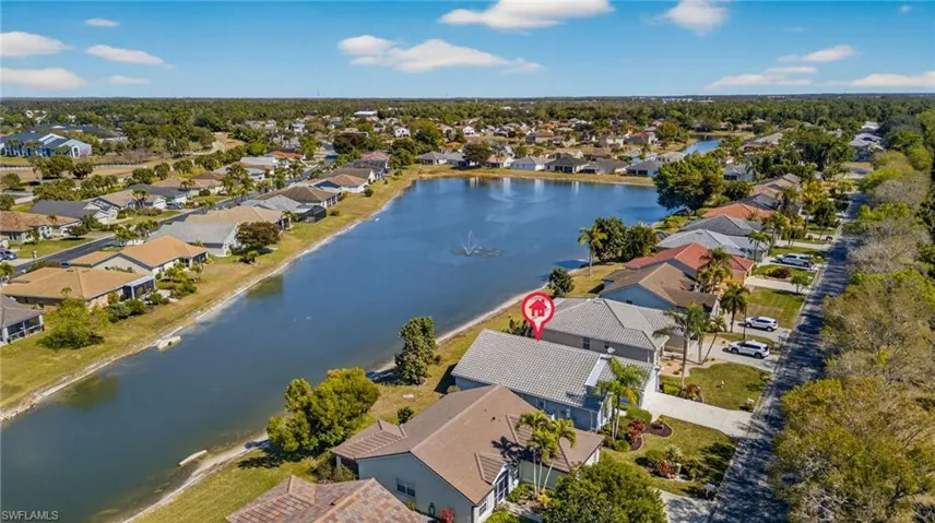 View of property location featuring a nearby body of water and nearby suburban area