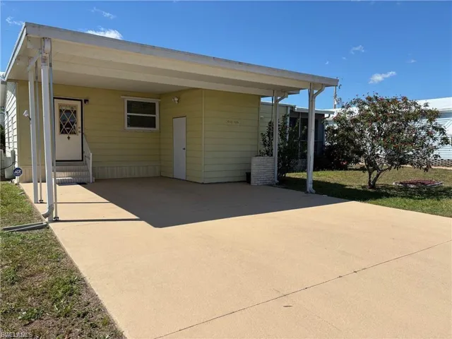 View of patio / terrace featuring a carport and driveway