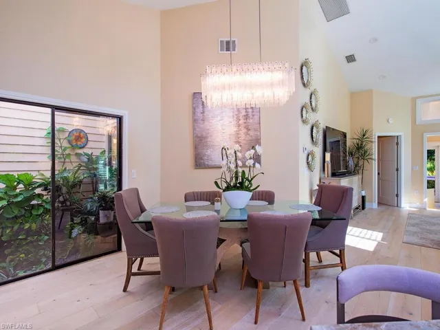 Dining space with a high ceiling and atrium views