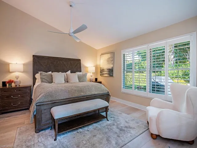 Bedroom with patio views, lofted ceiling and ceiling fan