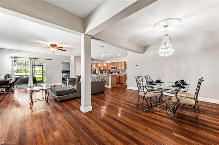 Dining area featuring dark hardwood / wood-style floors and ceiling fan with notable chandelier