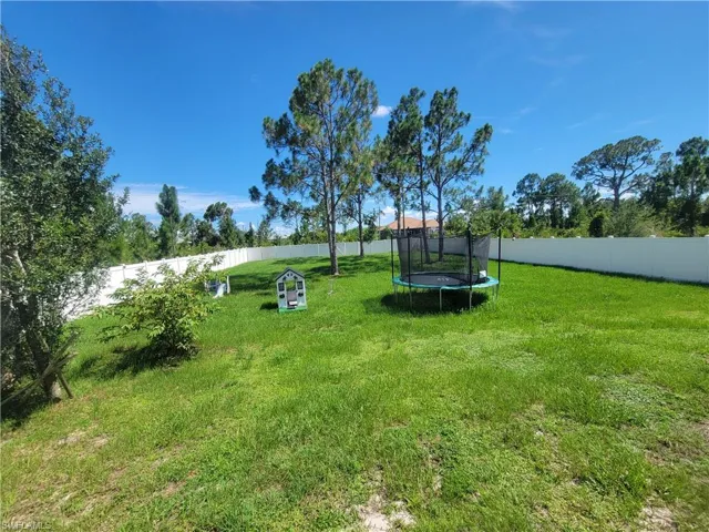 View of yard with a trampoline