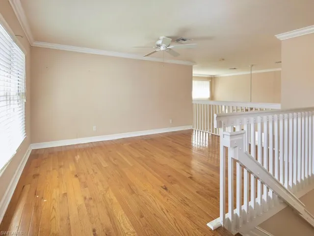 Spare room featuring ceiling fan, ornamental molding, and hardwood / wood-style floors