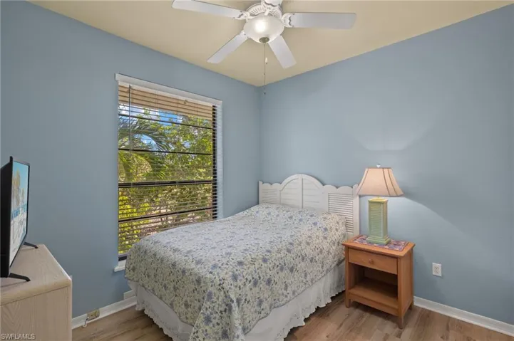 Bedroom with wood finished floors and a ceiling fan