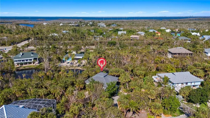 Aerial overview of property's location with nearby suburban area and a nearby body of water