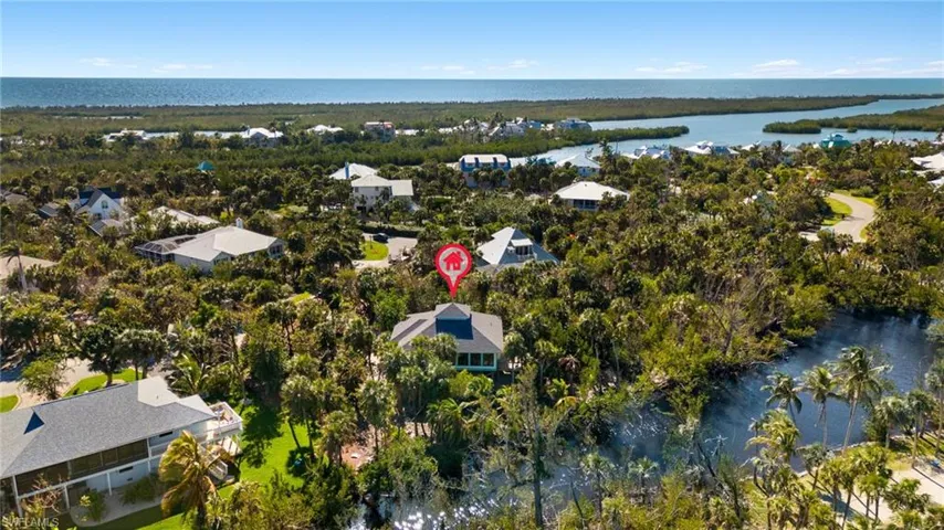 Aerial view of residential area featuring a large body of water