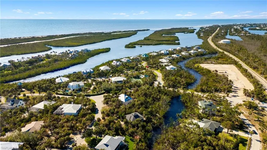 Aerial perspective of suburban area featuring a large body of water