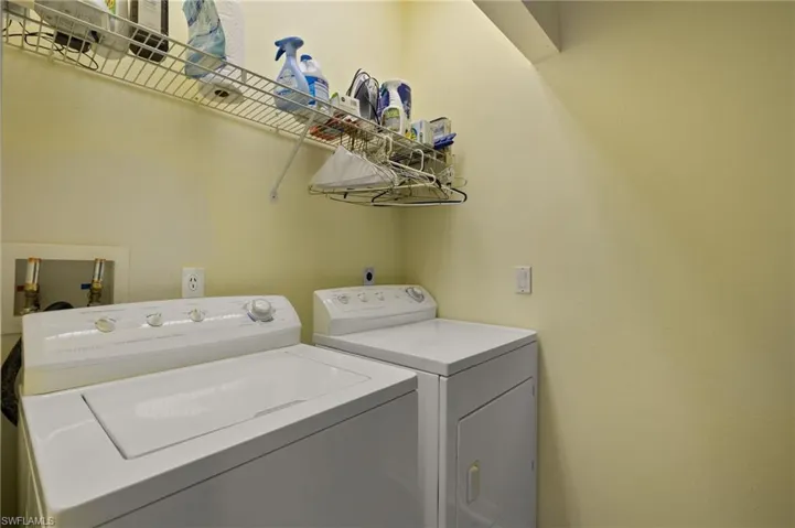 Laundry room with washer and clothes dryer