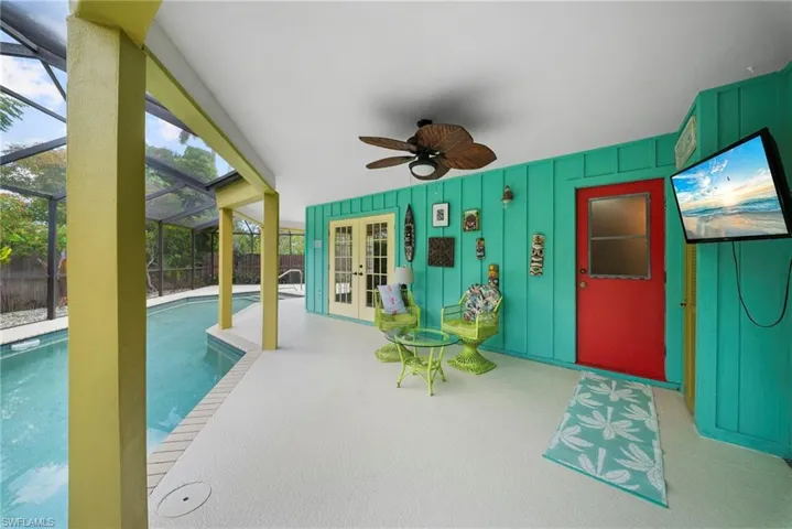 Screened lanai featuring a ceiling fan, direct pool access, and two sets of double French doors