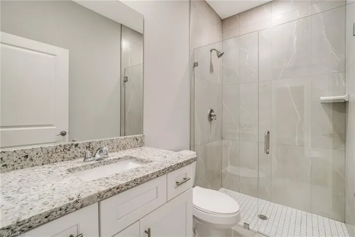 Full bath with vanity and a stall shower
