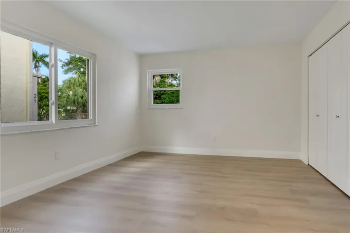Unfurnished bedroom featuring light wood-style floors and a closet