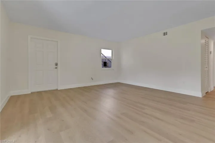 Spare room with light wood-style floors and baseboards