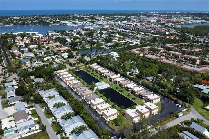Aerial view of property's location featuring a large body of water
