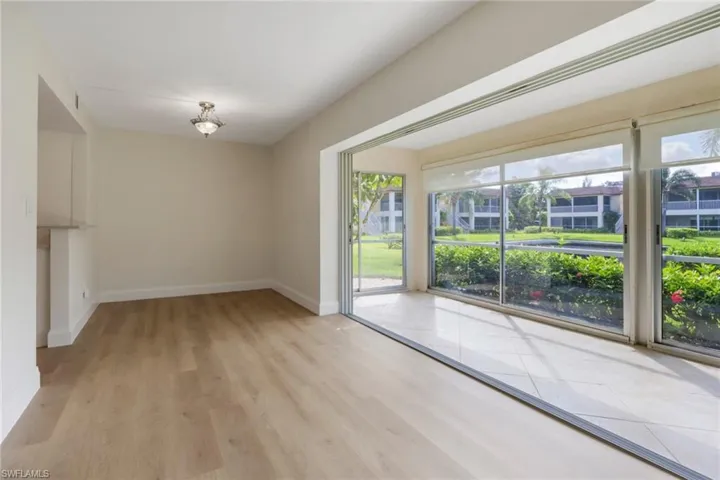 Unfurnished dining area featuring light wood finished floors and baseboards
