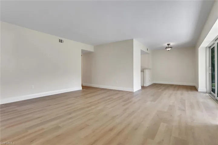 Unfurnished living room featuring light wood-style floors