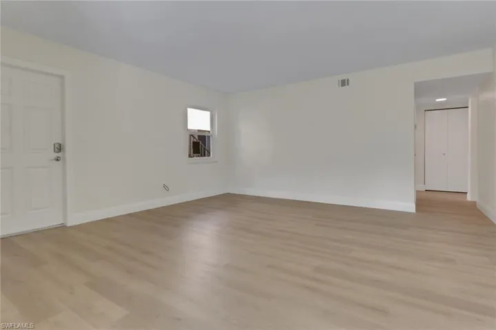 Spare room featuring light wood finished floors and baseboards