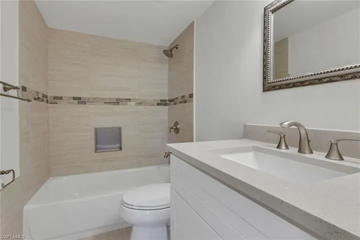 Bathroom with vanity and washtub / shower combination