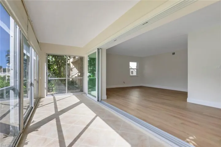 Unfurnished sunroom featuring baseboards and tile patterned floors