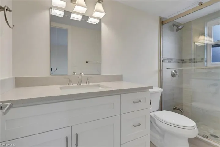 Full bathroom with a stall shower and vanity