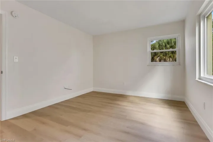 Unfurnished room with healthy amount of natural light and light wood-style floors