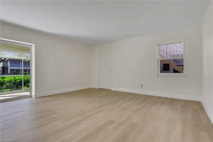 Empty room with light wood-style flooring and baseboards