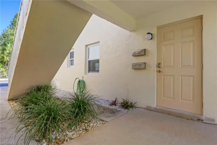 Property entrance with stucco siding