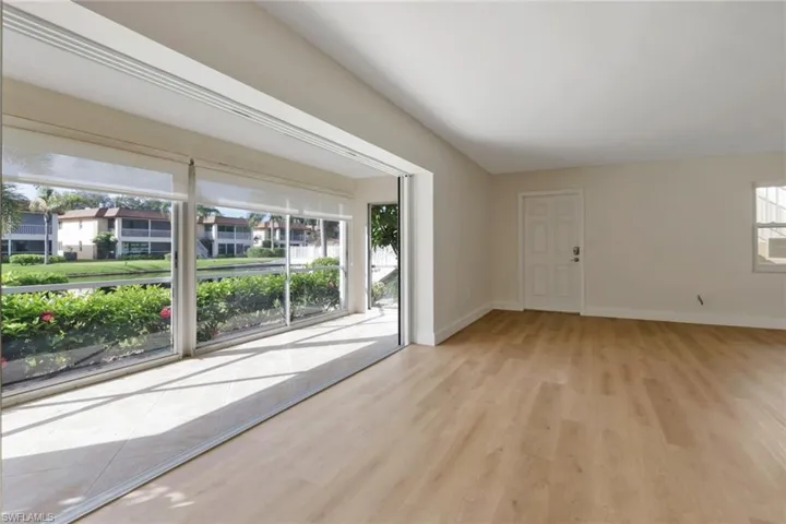 Spare room featuring baseboards and light wood-style floors