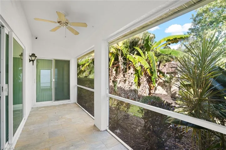 Unfurnished sunroom with ceiling fan and vaulted ceiling
