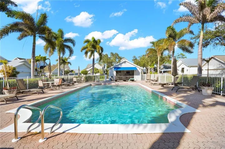 Community pool featuring a patio area and a residential view