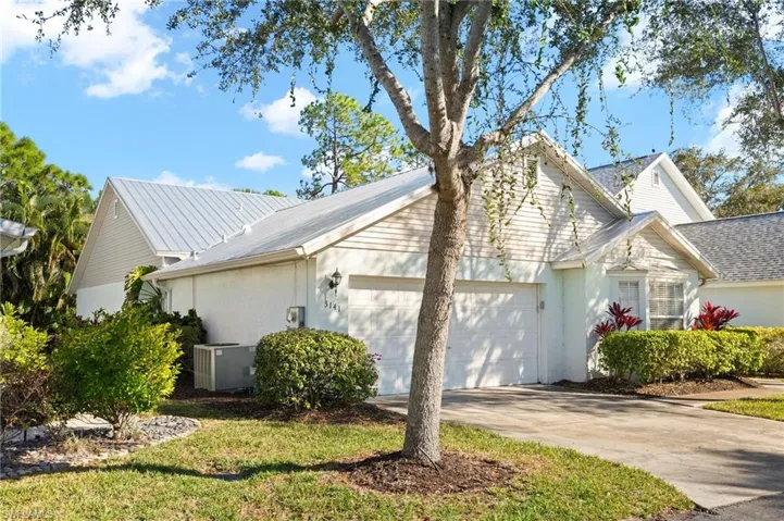 View of property exterior featuring a garage, driveway, and stucco siding