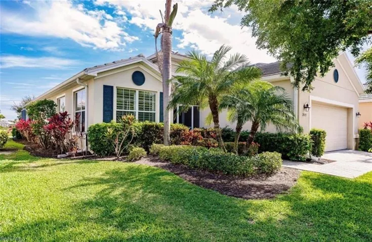 Single story home with a garage and a front yard