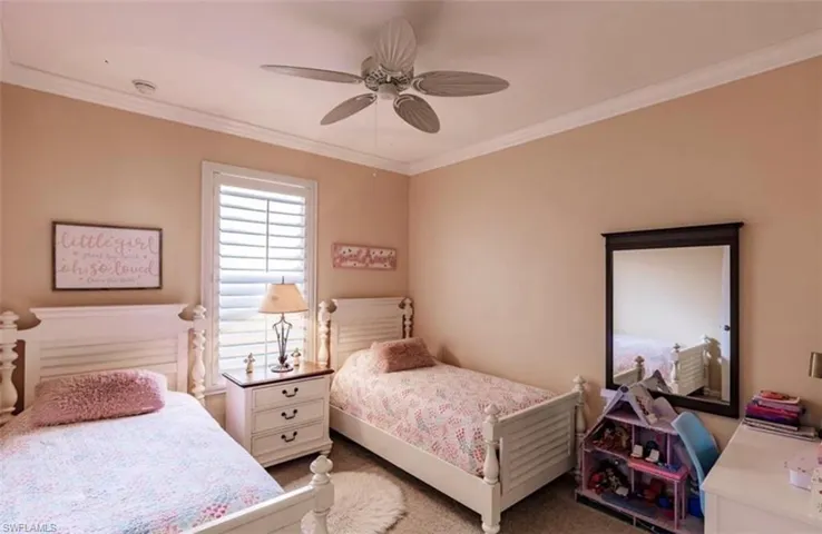 Bedroom with carpet flooring, ceiling fan, and ornamental molding