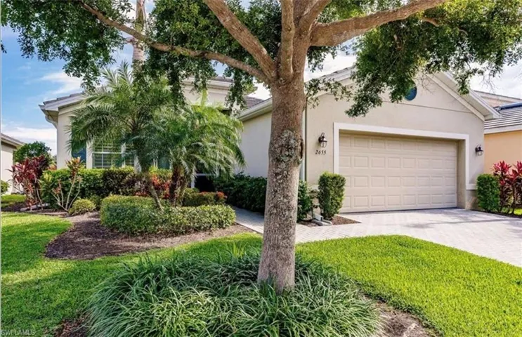 View of front facade with a garage and a front lawn