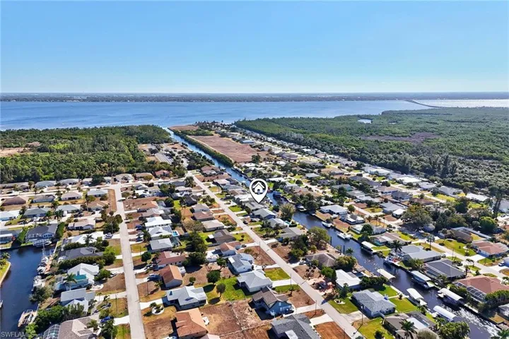 Aerial view of property's location with nearby suburban area and a nearby body of water