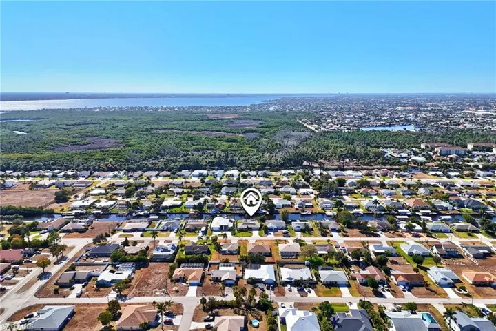 Aerial overview of property's location with nearby suburban area and a large body of water