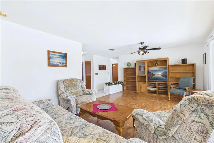 Living room featuring wood finished floors and a ceiling fan