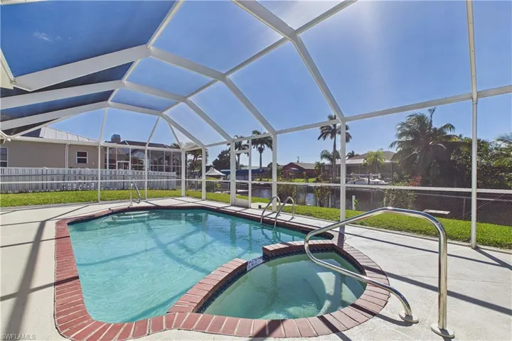 Combined pool / hot tub featuring a lanai, a sunroom, and a patio area